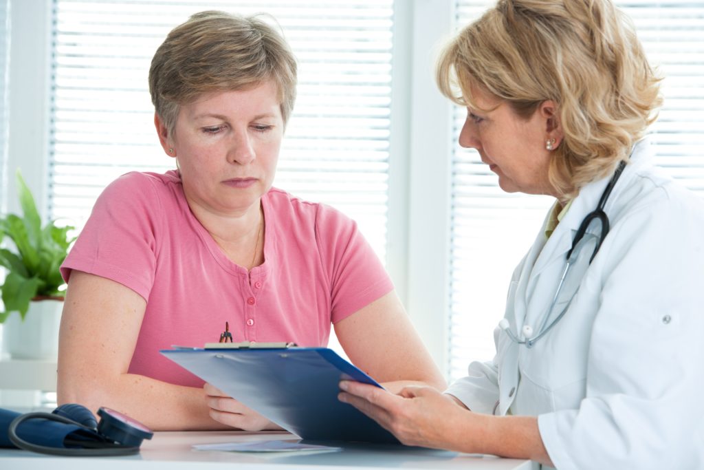 physician discusses test results with her female patient