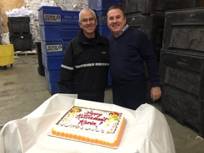 photo of men smiling with cake